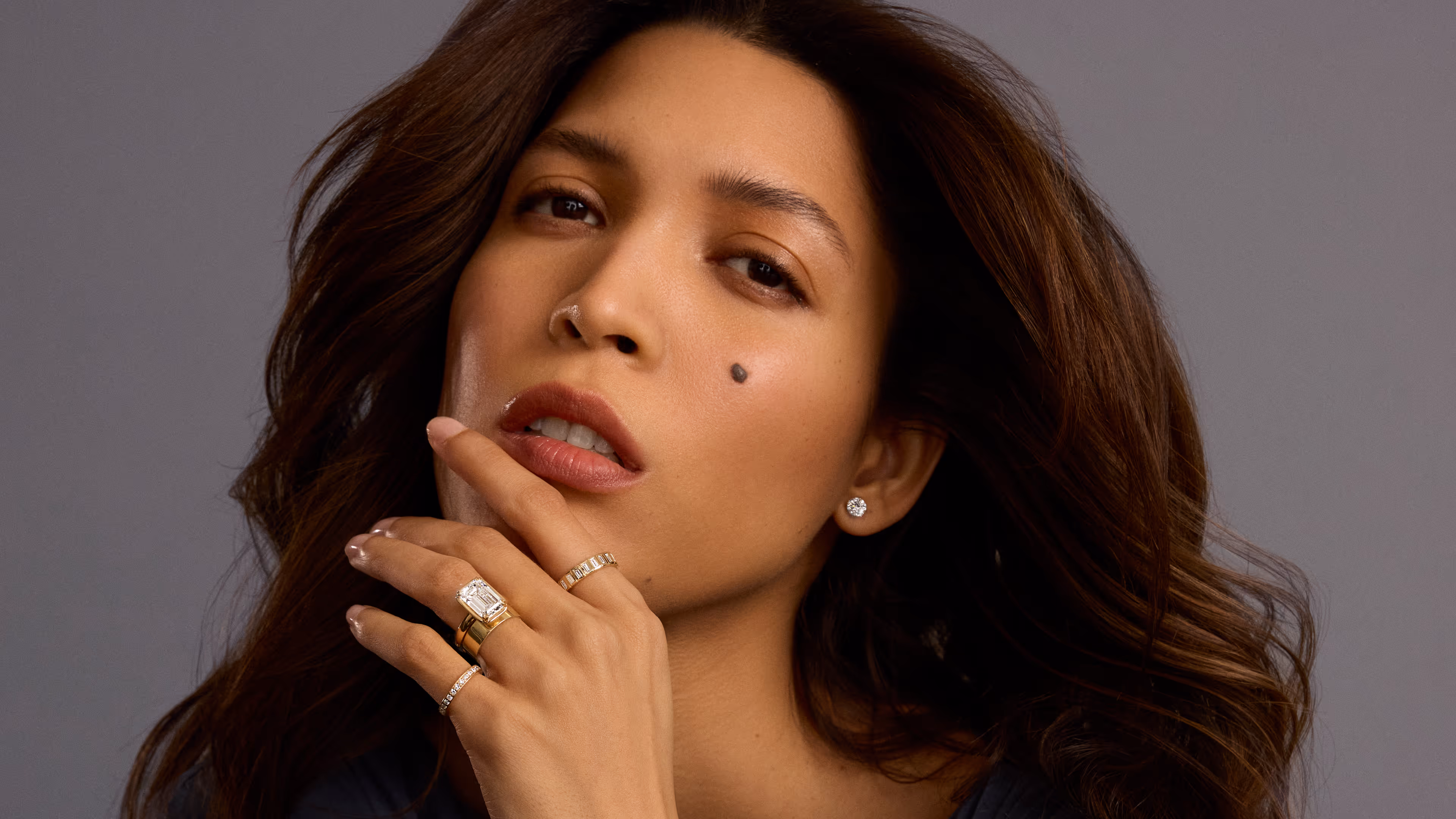 A close-up of an engagement ring with text overlay reading 'Find the Perfect Ring, Make it yours' against a dark background