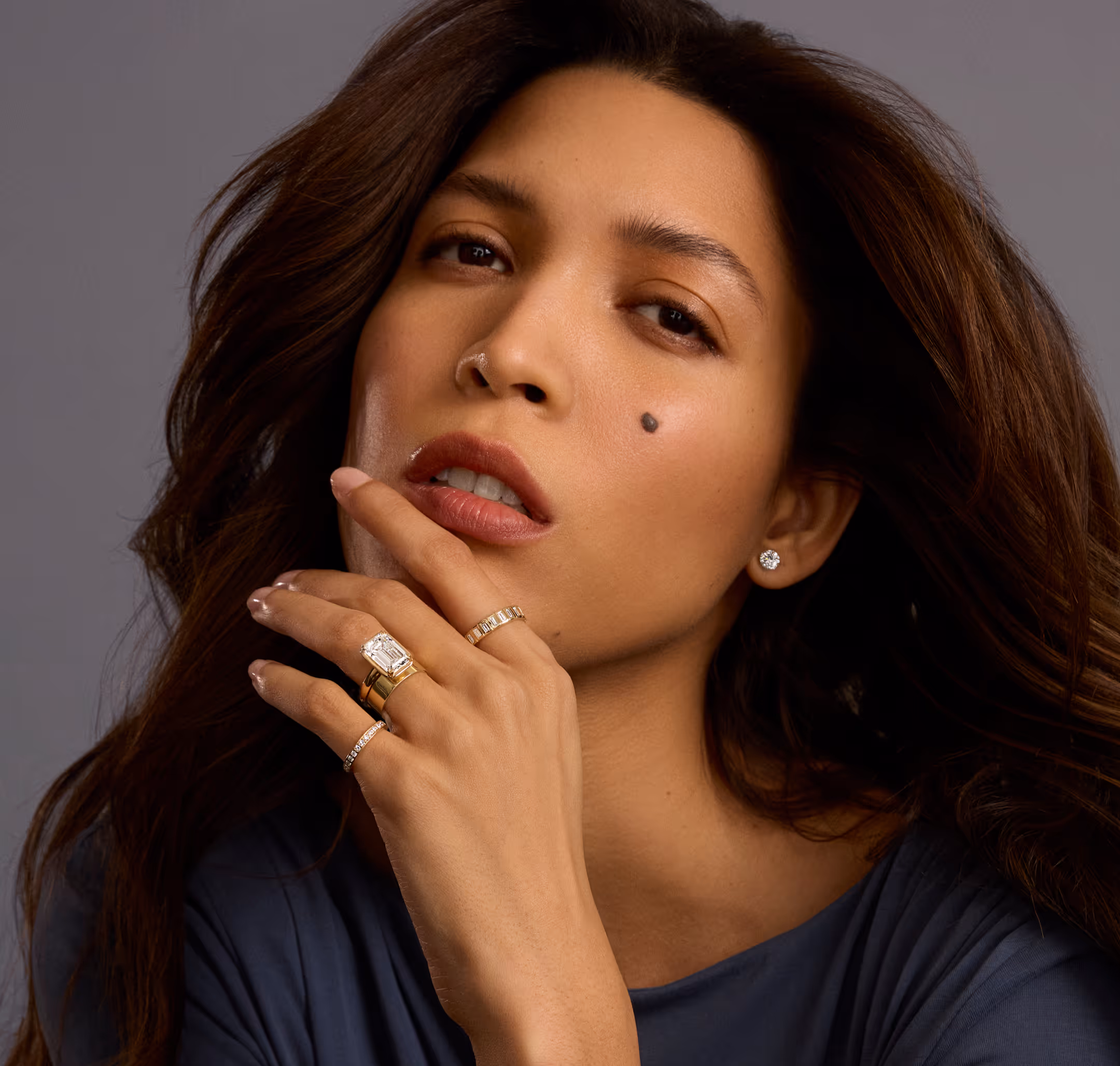 A close-up of an engagement ring with text overlay reading 'Find the Perfect Ring, Make it yours' against a dark background